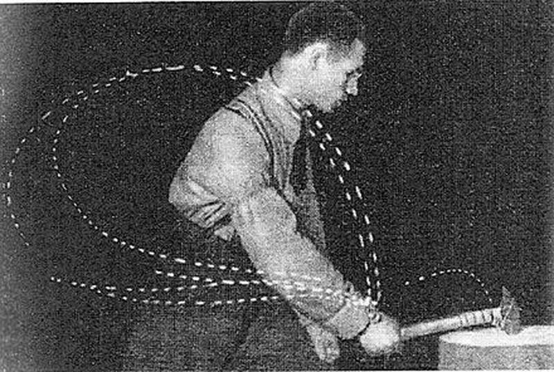 Bernstein's cyclogram: a black and white photograph of a blacksmith swinging a hammer, with dotted light traces marking the paths of his shoulder, elbow and wrist joints.